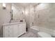 Neutral bathroom with marble countertops, glass shower door, and built-in tub at 3894 Land O Lakes Ne Dr, Atlanta, GA 30342