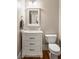 Well-lit bathroom featuring a single vanity, marble countertop, and hardwood floors at 3894 Land O Lakes Ne Dr, Atlanta, GA 30342