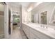 Elegant bathroom with double vanity, framed mirror, and a separate glass-enclosed shower at 3894 Land O Lakes Ne Dr, Atlanta, GA 30342