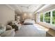 Spacious main bedroom with seating area, large window, and tray ceilings at 3894 Land O Lakes Ne Dr, Atlanta, GA 30342