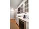 Butler pantry with wine storage, beverage cooler, and white cabinets at 3894 Land O Lakes Ne Dr, Atlanta, GA 30342