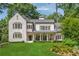 Stunning white brick home with manicured lawn and classic architectural details at 3894 Land O Lakes Ne Dr, Atlanta, GA 30342