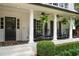 Charming front porch featuring rocking chairs, ferns, and white brick columns at 3894 Land O Lakes Ne Dr, Atlanta, GA 30342