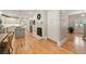 Bright kitchen with white cabinets, stainless steel appliances, hardwood floors, and a fireplace at 3894 Land O Lakes Ne Dr, Atlanta, GA 30342