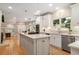 Open kitchen with island, stainless steel appliances, and breakfast nook view at 3894 Land O Lakes Ne Dr, Atlanta, GA 30342