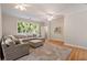 Spacious living room with hardwood floors, a comfortable seating area, and plenty of natural light at 3894 Land O Lakes Ne Dr, Atlanta, GA 30342