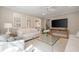 Comfortable living room with large windows and a modern glass coffee table at 3894 Land O Lakes Ne Dr, Atlanta, GA 30342