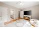 Open-concept room with hardwood floors, a comfortable seating area, and ample natural light at 3894 Land O Lakes Ne Dr, Atlanta, GA 30342