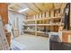 Unfinished basement space with a washer and dryer hook up and shelving at 7047 Bennington Ln, Cumming, GA 30041