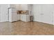 Basement kitchenette with white cabinets, tile backsplash, and convenient access to nearby storage or utility rooms at 7047 Bennington Ln, Cumming, GA 30041
