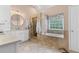 Elegant bathroom features a soaking tub, separate shower, and double vanity at 7047 Bennington Ln, Cumming, GA 30041