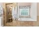 Elegant bathroom features a soaking tub and glass enclosed shower at 7047 Bennington Ln, Cumming, GA 30041