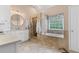 Bright bathroom offers a soaking tub, walk-in shower, and double vanity at 7047 Bennington Ln, Cumming, GA 30041