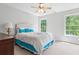 Bright bedroom with a ceiling fan, two windows, and carpet at 7047 Bennington Ln, Cumming, GA 30041