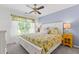 Cheerful bedroom with large window and floral bedding at 7047 Bennington Ln, Cumming, GA 30041