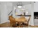 Bright dining room with wood floors, chandelier lighting and open to staircase and a living area at 7047 Bennington Ln, Cumming, GA 30041