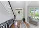Bright, airy foyer with beautiful hardwood floors, staircase, and natural light creating an inviting entrance at 7047 Bennington Ln, Cumming, GA 30041
