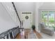 Inviting foyer with hardwood floors, bench seating, and a view of the staircase and front door at 7047 Bennington Ln, Cumming, GA 30041