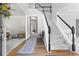 Bright foyer with hardwood floors, staircase, and elegant decor creates a welcoming entrance at 7047 Bennington Ln, Cumming, GA 30041