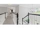 Upstairs hallway features open staircase with chandelier and nice finishes at 7047 Bennington Ln, Cumming, GA 30041