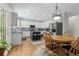 Bright eat-in kitchen features white cabinets, stainless steel appliances, an island and hardwood floors at 7047 Bennington Ln, Cumming, GA 30041