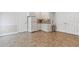 Basement kitchen features white cabinets, granite countertops, stainless steel appliances and tile floors at 7047 Bennington Ln, Cumming, GA 30041