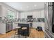 Bright kitchen featuring white cabinets, granite countertops, stainless steel appliances, and a functional center island at 7047 Bennington Ln, Cumming, GA 30041