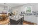 Open-concept kitchen with granite countertops, stainless steel appliances, breakfast nook, and a seamless transition to dining area at 7047 Bennington Ln, Cumming, GA 30041