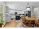 Sunlit kitchen with stainless steel appliances, white cabinetry, granite countertops, and a breakfast nook with a dining table at 7047 Bennington Ln, Cumming, GA 30041