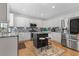 This kitchen has stainless steel appliances, granite countertops and a central island with stool seating at 7047 Bennington Ln, Cumming, GA 30041