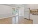 Bright kitchen area features a refrigerator, light cabinets, tile backsplash, and access to the backyard at 7047 Bennington Ln, Cumming, GA 30041