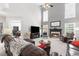 Spacious living room with fireplace, large leather sofas, tall ceilings, and plenty of natural light at 7047 Bennington Ln, Cumming, GA 30041