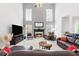 Comfortable living room with fireplace, two-story ceiling, and open layout, perfect for entertaining at 7047 Bennington Ln, Cumming, GA 30041
