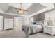 Spacious main bedroom boasts trey ceiling, sitting area, and ensuite bathroom at 7047 Bennington Ln, Cumming, GA 30041