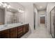 Bathroom featuring a double sink vanity, a large mirror, and a glass-enclosed shower with sleek fixtures at 18 Dorothy Ln, Lawrenceville, GA 30046