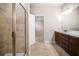 Bathroom featuring a shower, vanity with ample countertop space, and neutral tile flooring at 18 Dorothy Ln, Lawrenceville, GA 30046