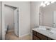 Half bathroom with neutral paint, a brown vanity, and tile flooring for a calm design at 18 Dorothy Ln, Lawrenceville, GA 30046
