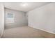 Carpeted bedroom with a window and neutral paint offers a bright, relaxing space at 18 Dorothy Ln, Lawrenceville, GA 30046