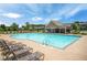 Community pool view showcasing a tranquil swimming space with lounge chairs and a covered area at 18 Dorothy Ln, Lawrenceville, GA 30046