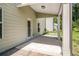 Covered patio with a concrete floor and white pillars, perfect for enjoying the outdoors at 18 Dorothy Ln, Lawrenceville, GA 30046