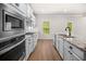Modern kitchen with stainless steel appliances, granite countertops, and a view to the exterior at 18 Dorothy Ln, Lawrenceville, GA 30046