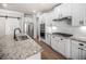 Bright kitchen features granite countertops, stainless steel appliances, and sleek white cabinetry at 18 Dorothy Ln, Lawrenceville, GA 30046