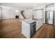 Bright kitchen island with granite countertops, stainless steel appliances, and a view of the fireplace and living room at 18 Dorothy Ln, Lawrenceville, GA 30046