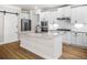 Modern kitchen island with stainless appliances, granite counters, white cabinets, and a sliding pantry door at 18 Dorothy Ln, Lawrenceville, GA 30046