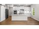 Modern kitchen with white cabinets, stainless steel appliances, granite countertops, and wood flooring at 18 Dorothy Ln, Lawrenceville, GA 30046
