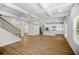 Spacious living room with coffered ceiling and a kitchen with white cabinets and stainless steel appliances at 18 Dorothy Ln, Lawrenceville, GA 30046