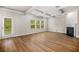 Bright living room with a fireplace, hardwood floors, coffered ceilings, and a back door to the yard at 18 Dorothy Ln, Lawrenceville, GA 30046