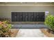 A large set of black mailboxes for the community, framed by a pathway and greenery at 18 Dorothy Ln, Lawrenceville, GA 30046