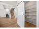 View of a walk-in pantry with a sliding barn door, next to a staircase and a living room at 18 Dorothy Ln, Lawrenceville, GA 30046