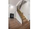 Carpeted stairway with wood and metal banister next to fireplace with hardwood floors at 18 Dorothy Ln, Lawrenceville, GA 30046